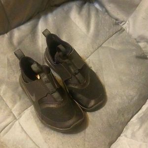 Child's slide on Nike tennis shoes in GUC. Size is a 12 C. Solid black.